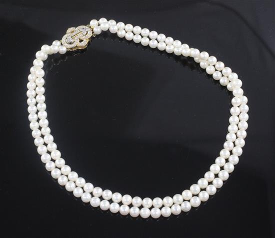 A double strand cultured pearl choker necklace with 18ct gold and diamond set clasp, 34cm.